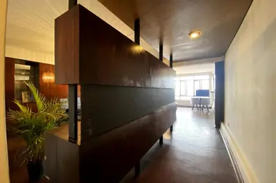 a living room with a large wooden wall at Elegant and spacious penthouse in Lima