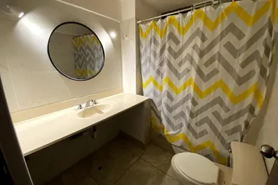 a bathroom with a sink and a mirror at Elegant and spacious penthouse in Lima