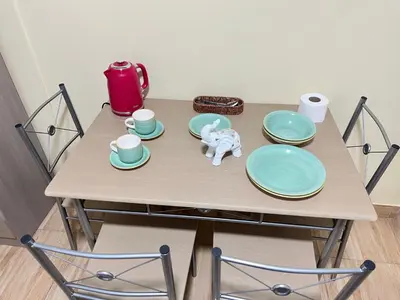 a table with plates and a toy elephant on it at Habitaciones privadas para alojamiento en Ica, Perú in Ica