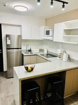 a kitchen with a counter with a bowl of fruit on it at Beautiful cozy apartment in Cusco
