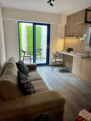 a living room with a couch and a table with chairs at Beautiful cozy apartment in Cusco