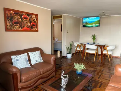 a living room with a couch and a table at Departamento privado en Lima in Lima