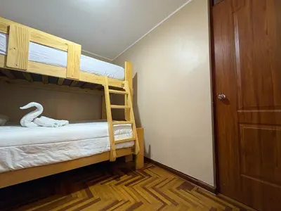 a bedroom with two bunk beds with a ladder at Departamento privado en Lima in Lima