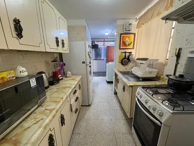 a kitchen with white cabinets and a stove at Departamento privado en Lima in Lima