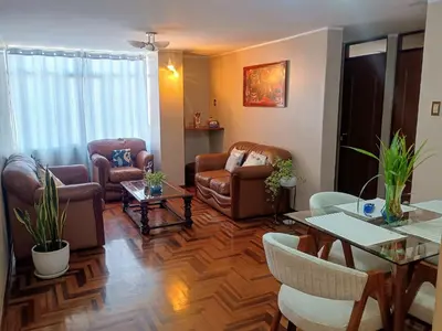 a living room with leather chairs and a table at Departamento privado en Lima in Lima