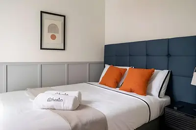 a bedroom with a large bed with orange pillows at Edificio Parque Castilla in Lima
