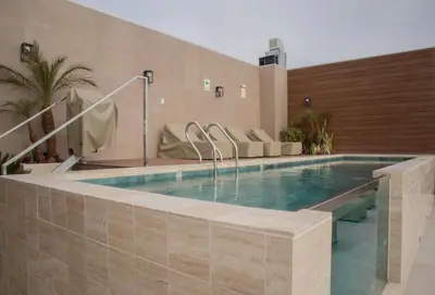 a swimming pool in a building with a swimming poolvisorvisor at Sight Oceanview in Barranco Malecon by Wynwood House in Lima