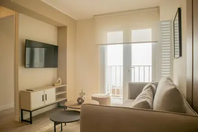a living room with a couch and a large window at Sight Oceanview in Barranco Malecon by Wynwood House in Lima