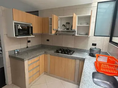 a kitchen with a counter top and a microwave at Casa de Stephano in Lima