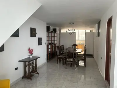 a dining room with a table and chairs at Casa de Stephano in Lima