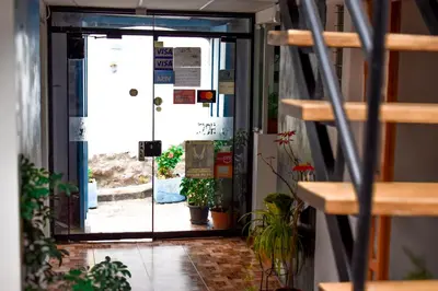 an open door of a building with potted plants at Apart Hotel El Puma in Cusco