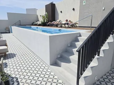 a swimming pool on the side of a building at New 1st Fl Executive Patio Pad in Lima