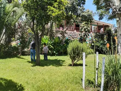 a man and a boy standing in a yard at Casa Jardin in Ayacucho