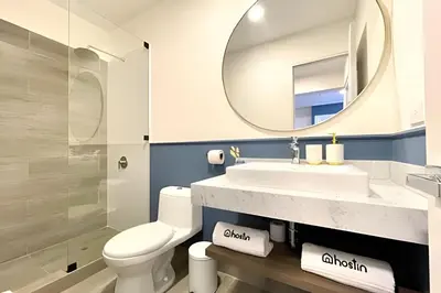 a bathroom with a sink and a toilet and a mirror at Edificio Plaza 27 in Lima