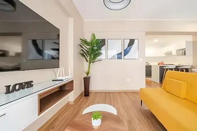 a living room with a yellow couch and a tv at Edificio Vital in Lima