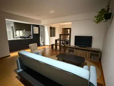 a living room with a couch and a tv at The Palms at Miraflores in Lima