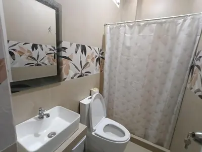 a bathroom with a toilet and a sink and a shower at Hospedaje Altamar in Paracas