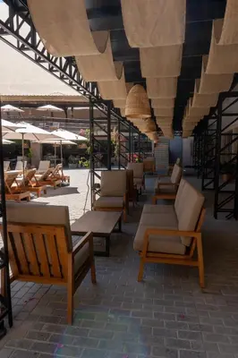 a row of chairs and umbrellas on a patio at Senoma Hotel - Adults only in Ica