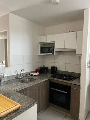 a kitchen with a sink and a stove top oven at Emilia House in Lima