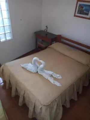 a bed with two swans made out of towels at Hostal Cusco Inn in Cusco
