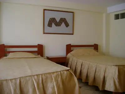 two beds sitting next to each other in a room at Hostal Cusco Inn in Cusco