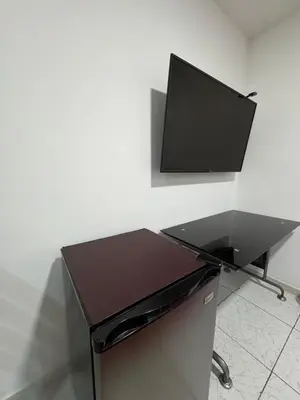 a computer desk with a monitor on top of it at alojamiento independiente baño privado in Lima