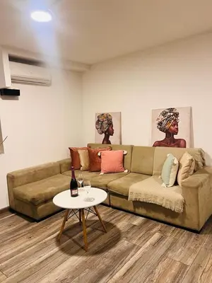 a living room with a couch and a table at Monterrico Polo Aparts #3 - Dpto con AC a una cuadra Embajada de USA in Lima