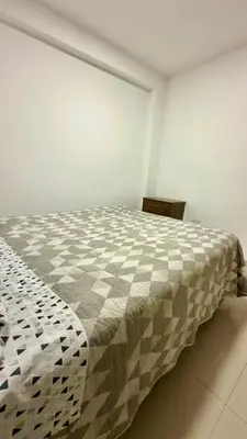 a bedroom with a bed in a white room at Departamento completo en el primer piso in Ayacucho