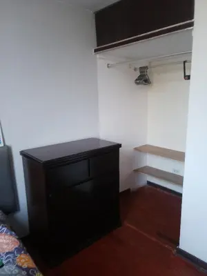 a bedroom with a black dresser in a room at Cuchos in Lima