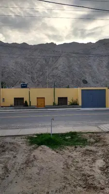 a building on the side of a road in the desert at Casa Langla Lunahuana in Lunahuaná