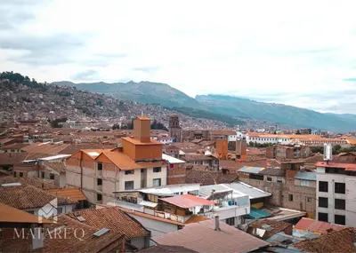 a view of a city with buildings and mountains at Luxury apartment steps from Plaza de Armas in Cusco