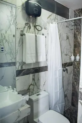 a bathroom with a toilet and a sink at Wake Up Near The Sea in Lima