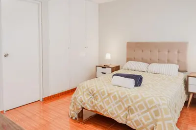 a bedroom with a bed with a blue and white blanket at Appealing 1BR Beautiful View in Miraflores in Lima
