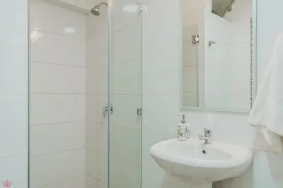 a bathroom with a sink and a glass shower at Appealing 1BR Beautiful View in Miraflores in Lima