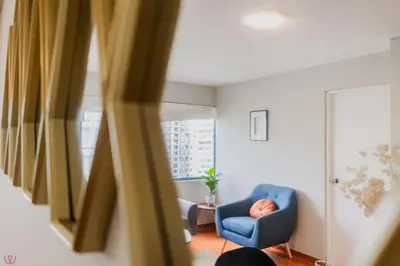 a room with a blue chair and a window at Appealing 1BR Beautiful View in Miraflores in Lima