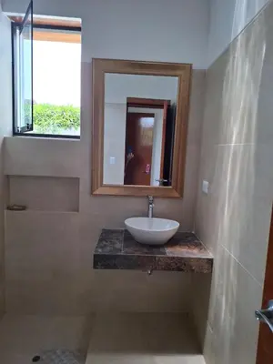 a bathroom with a sink and a mirror at Condominio ecológico las gardenias de Asia