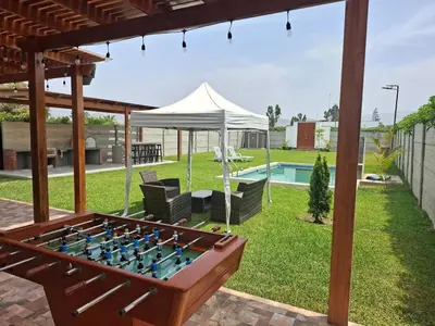 a backyard with a foosball table and a tent at Condominio ecológico las gardenias de Asia