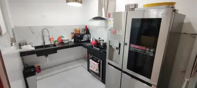 a kitchen with a refrigerator and a sink at Casa Oasis Meneses in Ica