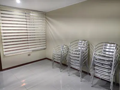 three metal chairs in a room with a window at Casa Oasis Meneses in Ica