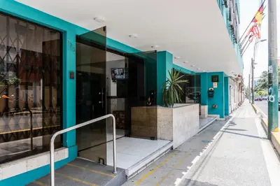 a building with blue walls on a street at Hotel Perú Pacífico in Lima