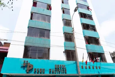a tall blue building with a sign in front of it at Hotel Perú Pacífico in Lima