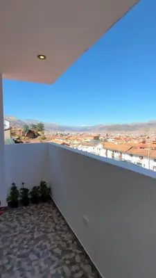 a balcony with a view of a city at La Casita De Colores Cusco in Cusco