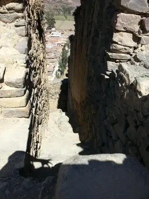 a stone wall on the side of a mountain at Kamma Guest House in Ollantaytambo