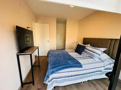 a bedroom with a bed and a flat screen tv at Monterrico Polo Aparts 19 - Dpto de Estreno con Balcon frente Embajada USA in Lima