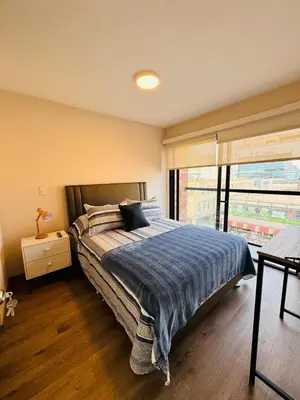 a bedroom with a large bed and a window at Monterrico Polo Aparts 19 - Dpto de Estreno con Balcon frente Embajada USA in Lima
