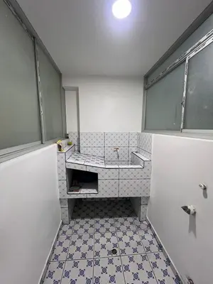 a bathroom with a sink and a tiled floor at Alojamiento ideal Equipado in Huancayo