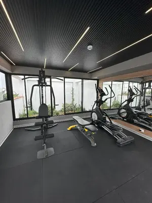 a gym with three exercise bikes in a room with windows at e-t*| Apartamento vista espectacular in Lima