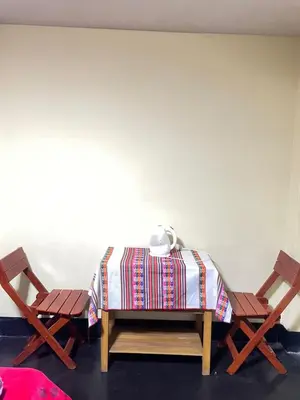 a table and two chairs in a room at Habitación a 15 min del Aeropuerto in Lima