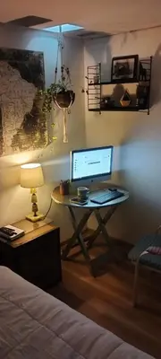 a desk with a computer on a table in a room at El Rosedal in Lima