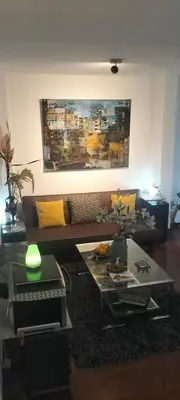 a living room with a couch and a table at El Rosedal in Lima